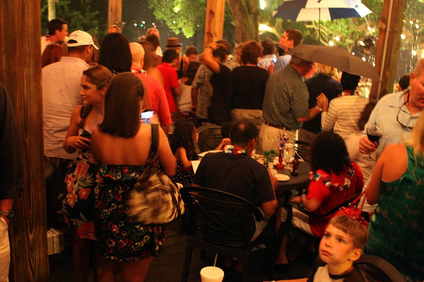 People rushed to get some shelter from the thunderstorm that rolled in during the fireworks display.