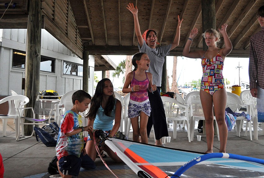 Farah Abidâ€™s, camp counselor, team celebrates after finishing putting their sail together before any of the other teams Friday, July 8 during the Island Style Water Sports Camp.