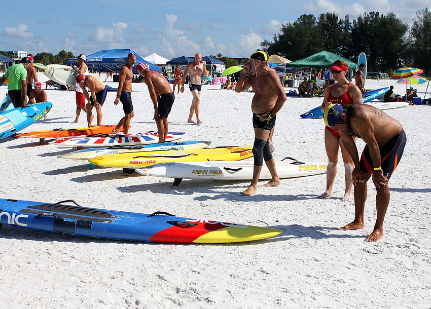 Lifeguards try and catch their breath after competing in the rescue board race.