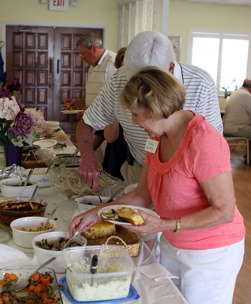 People lined up to get food Saturday, July 16 during the Christ Church and Spanish Main fish fry.