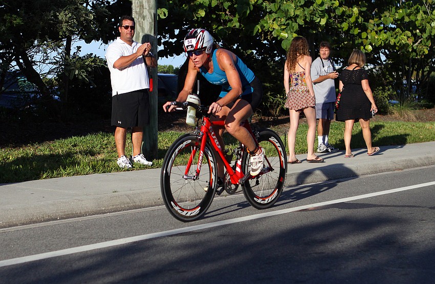 Kerry Simmons rides her bike down Beach road during the Siesta Key Triathlon Saturday, July 23 out at Siesta Key Public Beach.