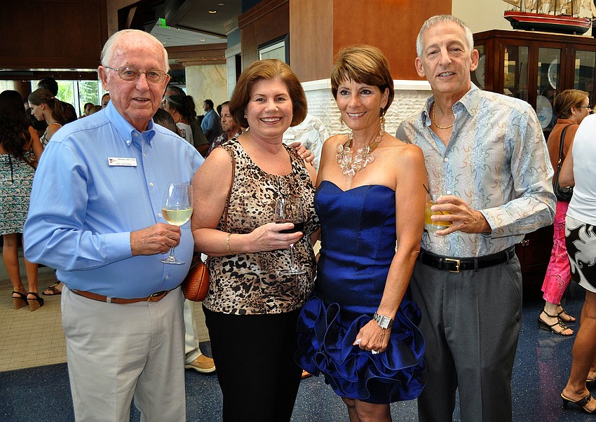 Ray and Jane Hutchins pose with Donna Farina and Alan Kesten in the lobby Saturday, August 6 during Scallopalooza at the Sarasota Yacht Club.