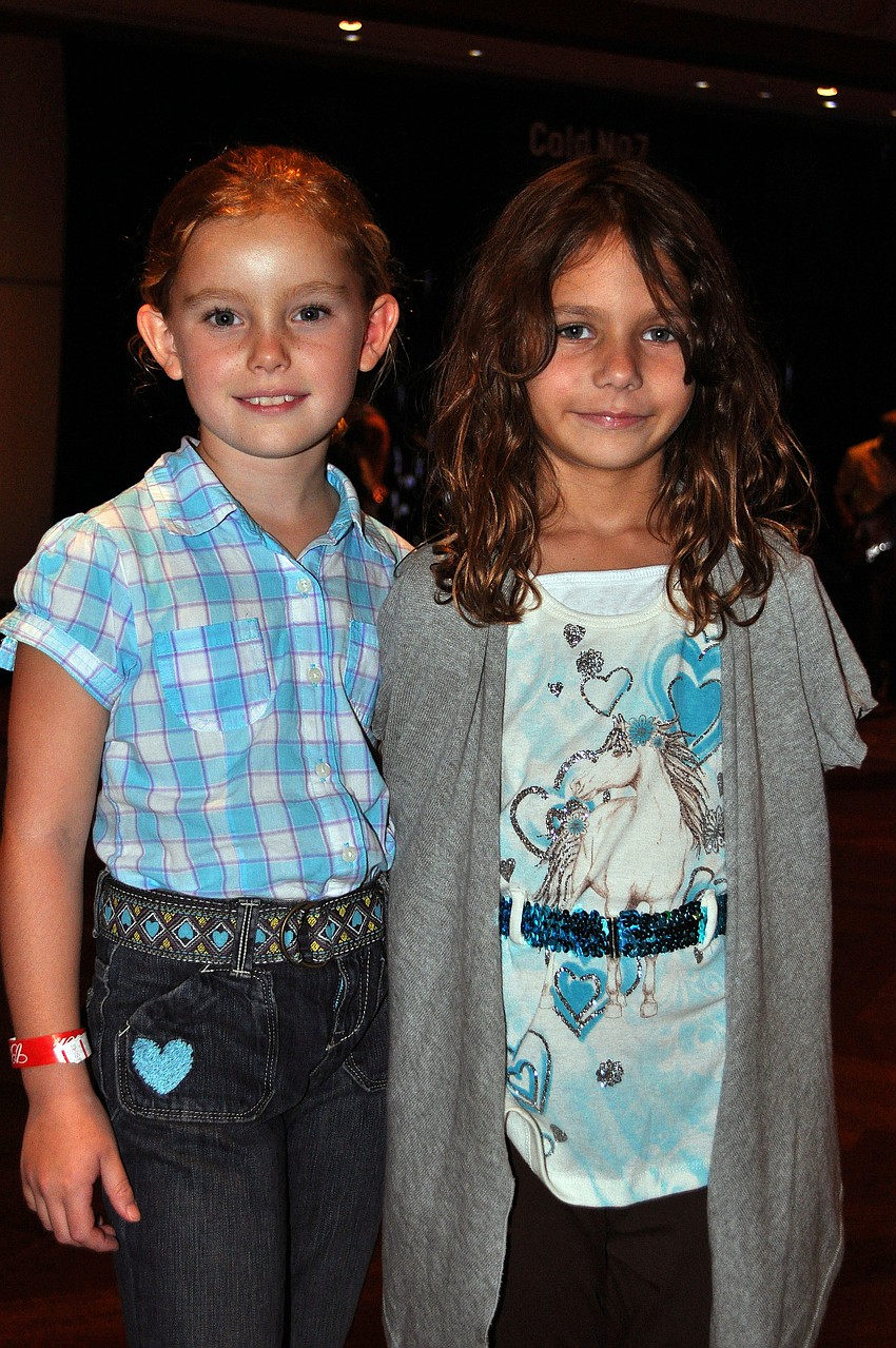 Cecilia Mould, 7, and Carly Birnbach, 7,pose together by the dance floor.