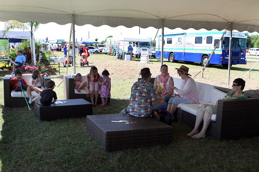 People hang out on comfy couches and chairs underneath a canopy on Saturday, March 19 at the Sarasota Springfest out at Palmer Ranch.