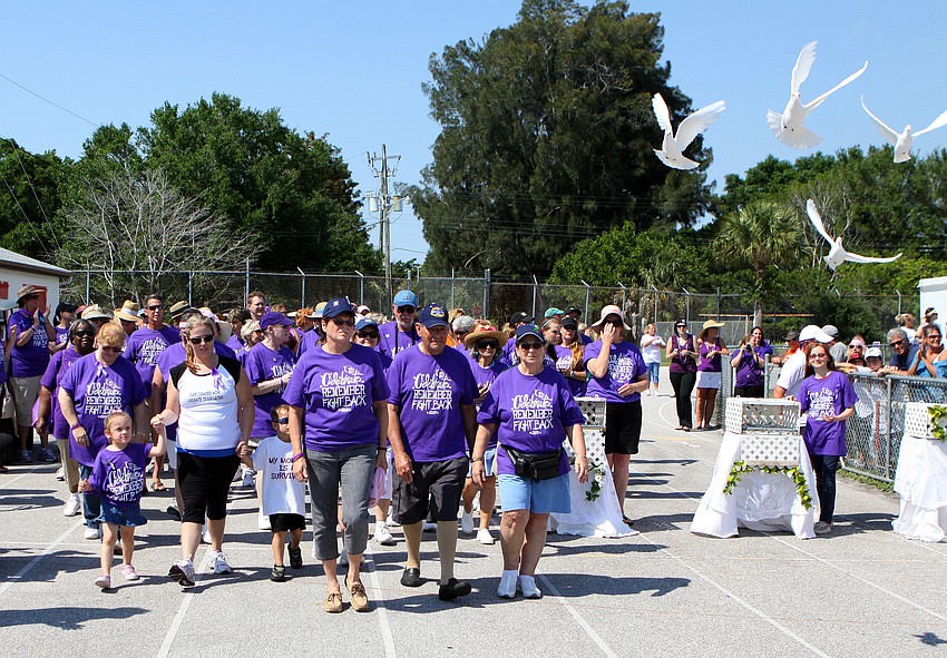 Survivors start their first lap while doves fly through the air on Saturday, April 9 at Sarasota High School.