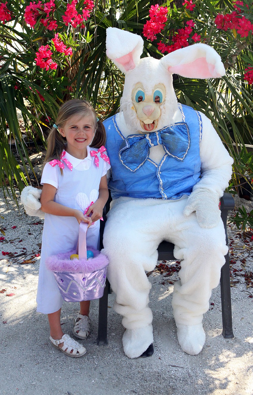 Brooke Swift poses with the Easter Bunny after collecting eggs from the Easter egg hunt.