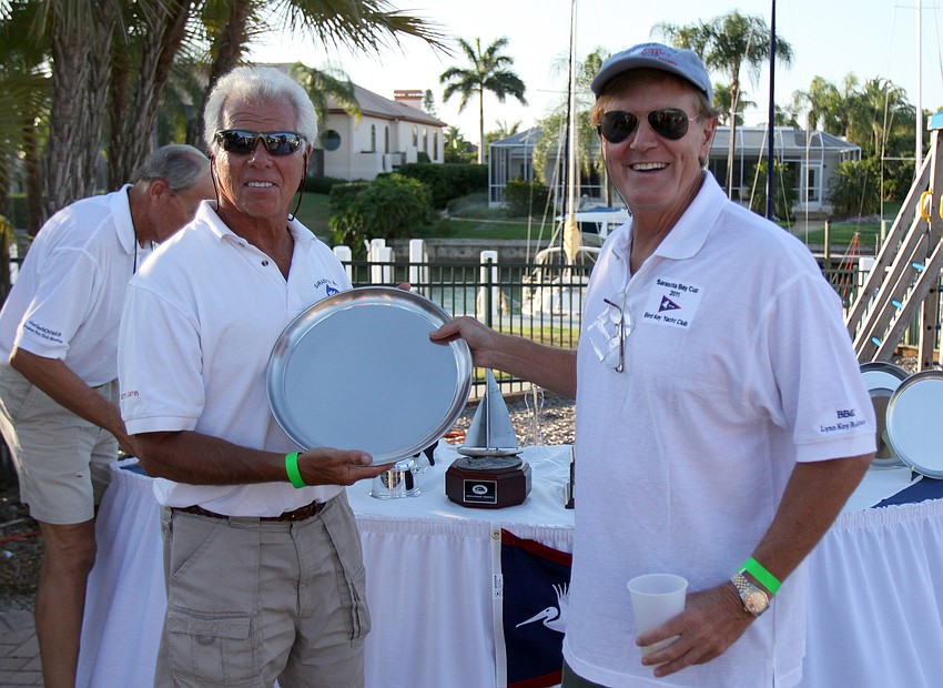 Commodore Bob Baime congratulates Bob Neff for winning 1st place in multi-hull Saturday, May 7 in the Sarasota Bay Cup at Bird Key Yacht Club.