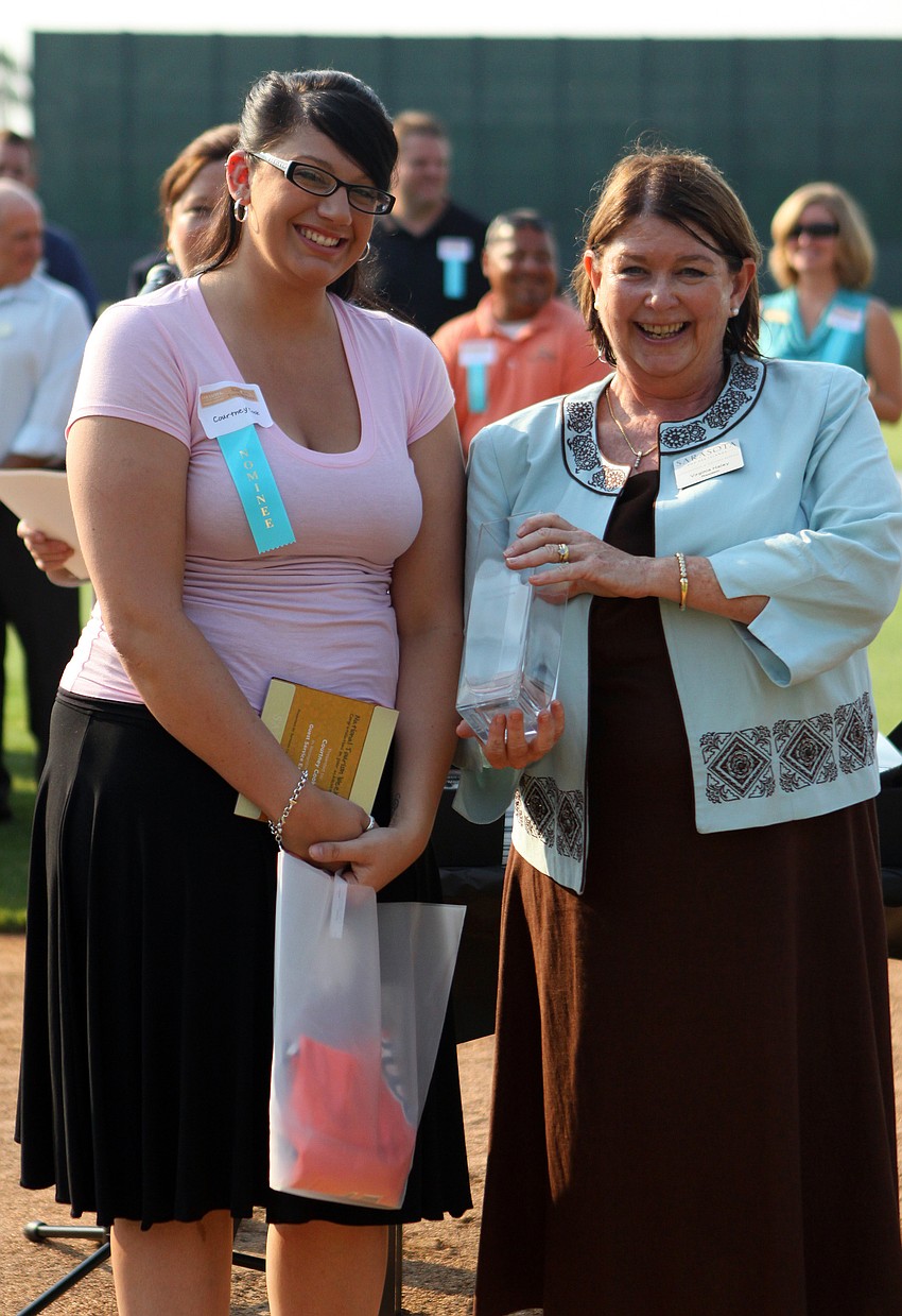 Virginia Haley presents Courtney Cook of Tropical Breeze Resort with the award for Guest Service Excellence - Lodging at the 2011 National Tourism Week Awards ceremony Thursday, May 12, at Ed Smith Stadium.