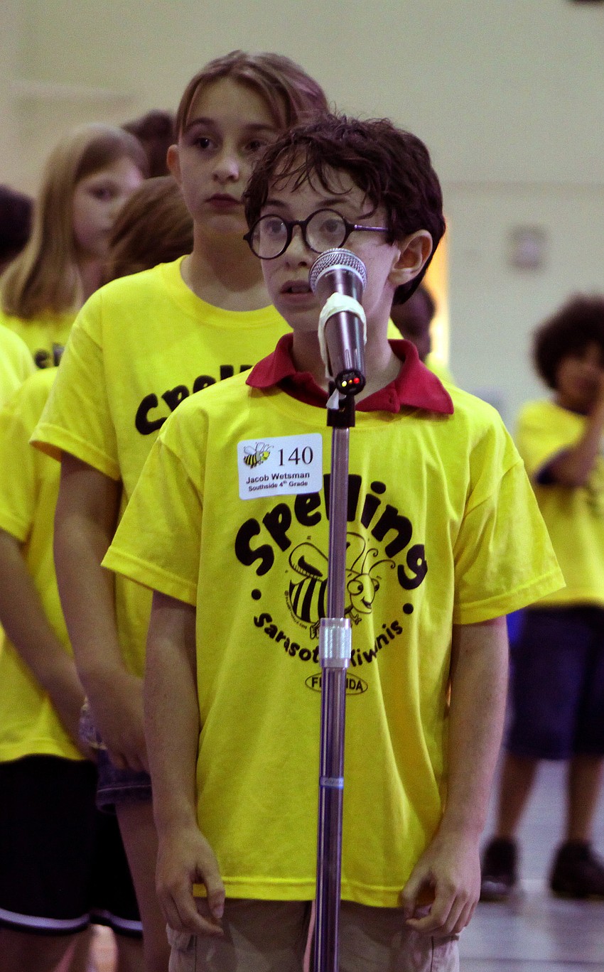Jacob Wetsman, a fourth grader from Southside, spells the word he is given into the microphone at the Sarasota Kiwanis Club's Spelling Bee Friday, May 13 at the Boys and Girls Club.