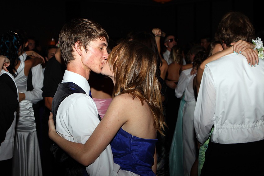 Anthony Alessandrini and Jennifer Serviss share a quick kiss while dancing to a slow song Saturday, May 14 at the Sarasota High School's prom at the Hyatt Regency.