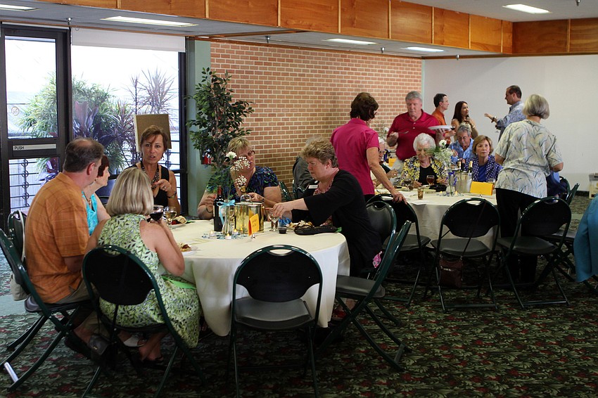 People enjoy plates of different desserts during Family Promises' Third Annual Just Desserts event Friday, May 20 at Selby Garden's Great Room by the Bay.