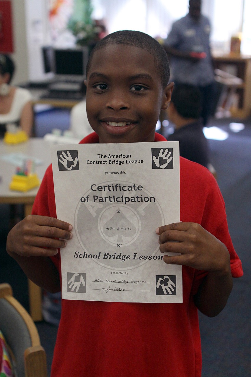 Arthur Brantley holds up his Certificate of Participation Monday, May 23 inside Gocico Elementary School's Media Center.