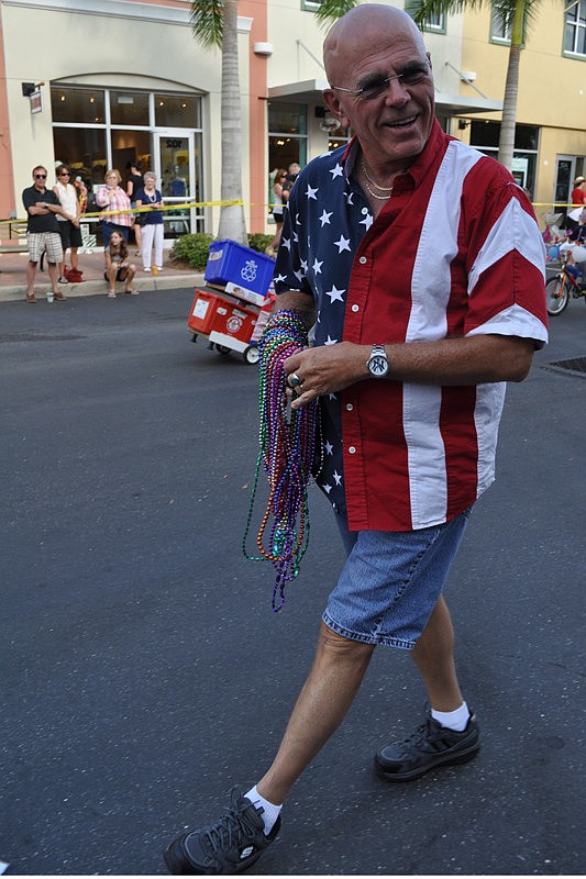 Gerry Sturn passed out beads with Manasota Operation Troop Support.