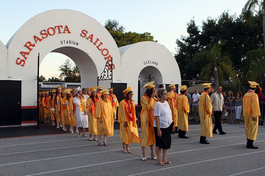 The seniors wait to be told when to begin to make their way around the track Friday, June 3 at Sarasota High School's graduation at Cleland Stadium.