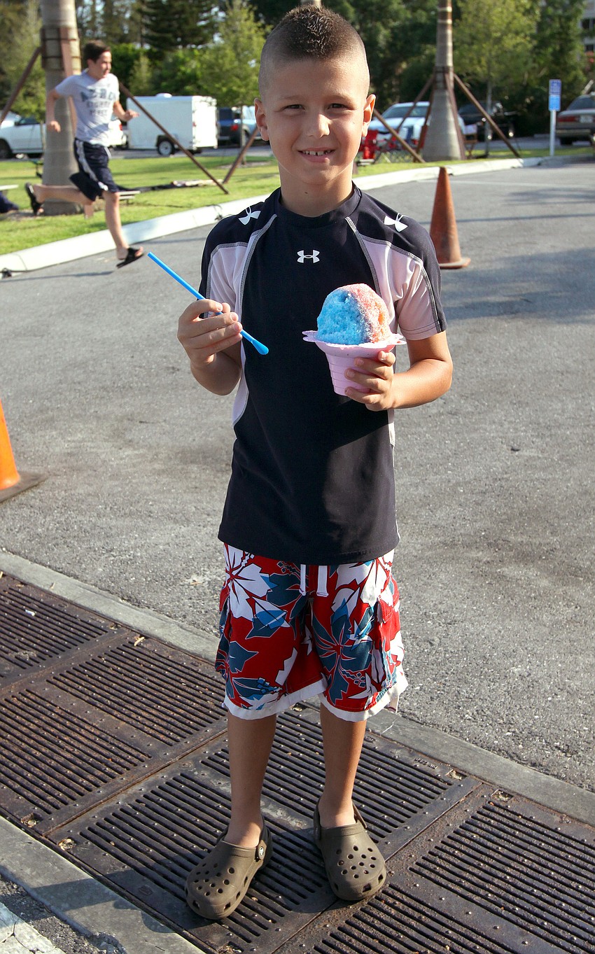 Luke Labriola enjoys a red and blue Hawaiian Ice.