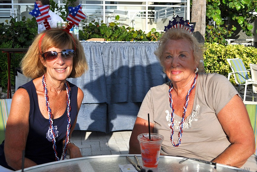 Barbara Kuzmich and Leah Barker brought their own festive beads and headwear to the Lobster BBQ Sunday, July 3 at the Longboat Key Club Resort.