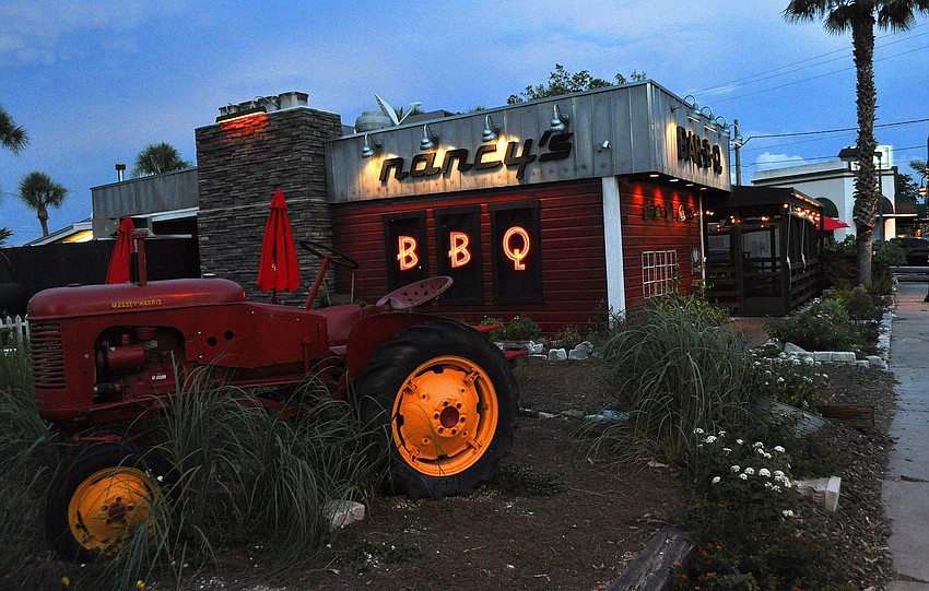 Nancyâ€™s BBQ lights up the intersection of Pineapple and Cross at night Thursday, June 23 in the Pineapple Historic District.