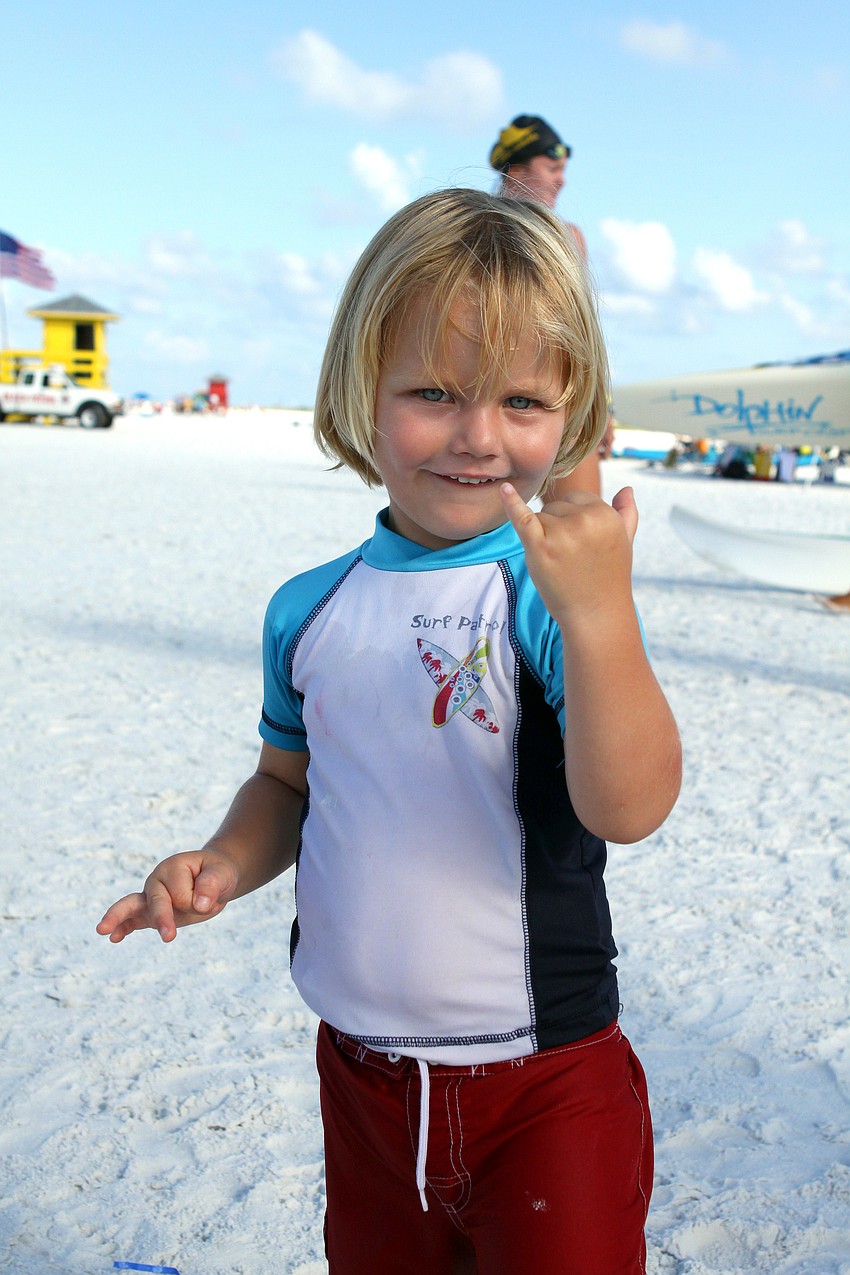 Drew Ritchie, 3, of Vero Beach, shows off his surfer dude hand signal Thursday, July 14 while watching his dad compete in the 2011 James 