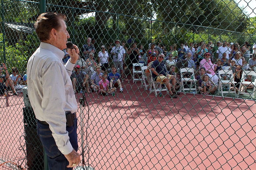 D.M. Williams talks to the crowd of people to let them know the new height of the cotton plant Friday, July 15 at Casa del Mar.