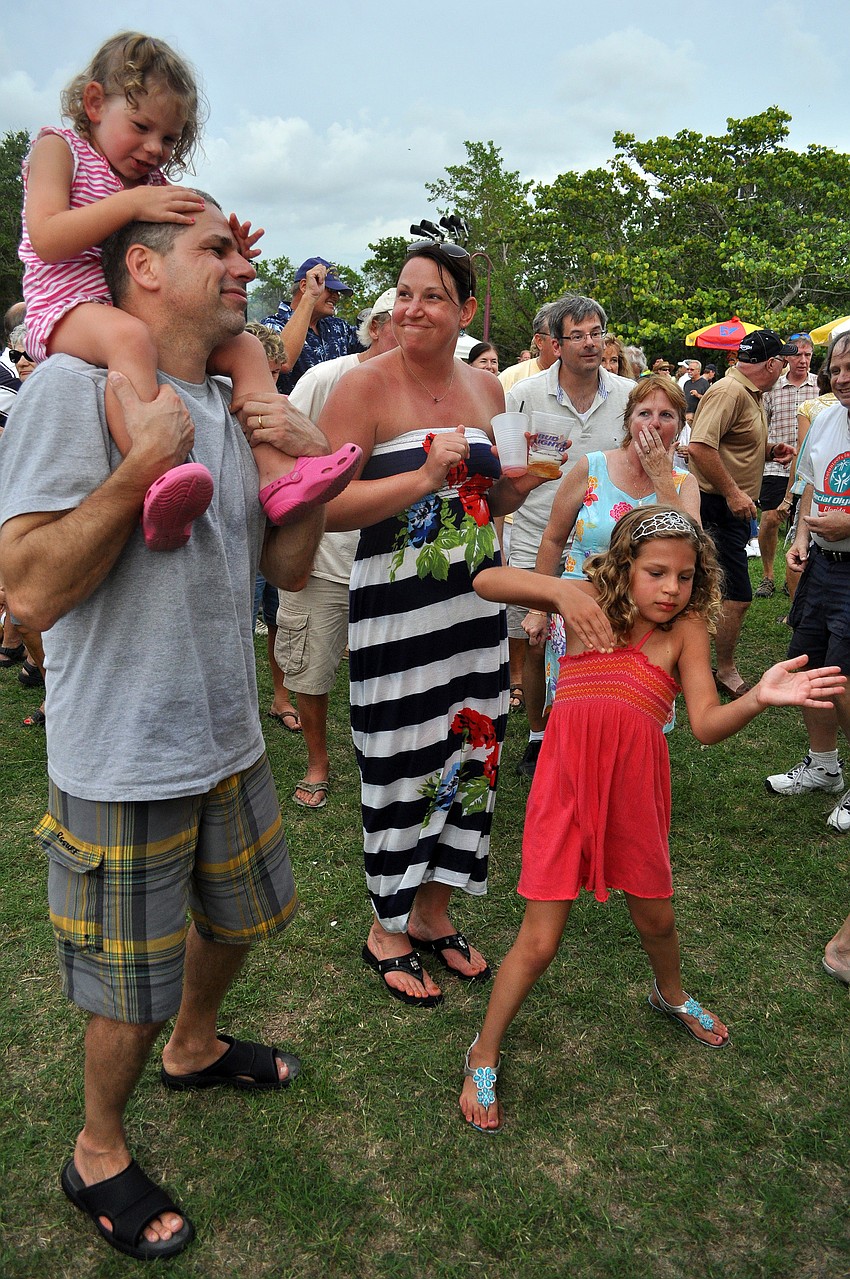 Josephine, 3, sits on Mikeâ€™s shoulders while Cynthia and Ila, 6, Raso dance to the music played by Yesterdayze Friday, July 15 at Friday Fest at the Van Wezel.
