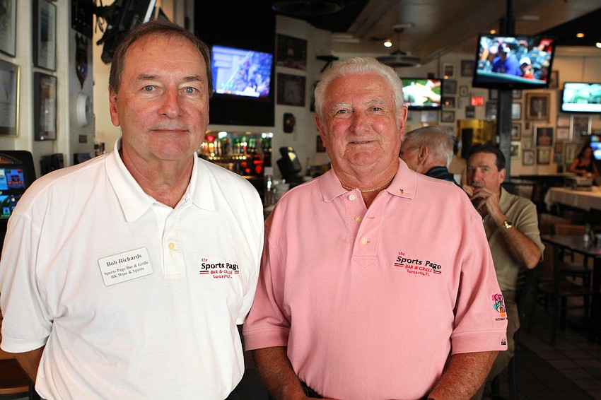 Bob Richards and Kenny Barr, the co-owners of the Sports Page, pose together during the Longboat Key Chamber event Thursday, July 21 at the Sports Page.