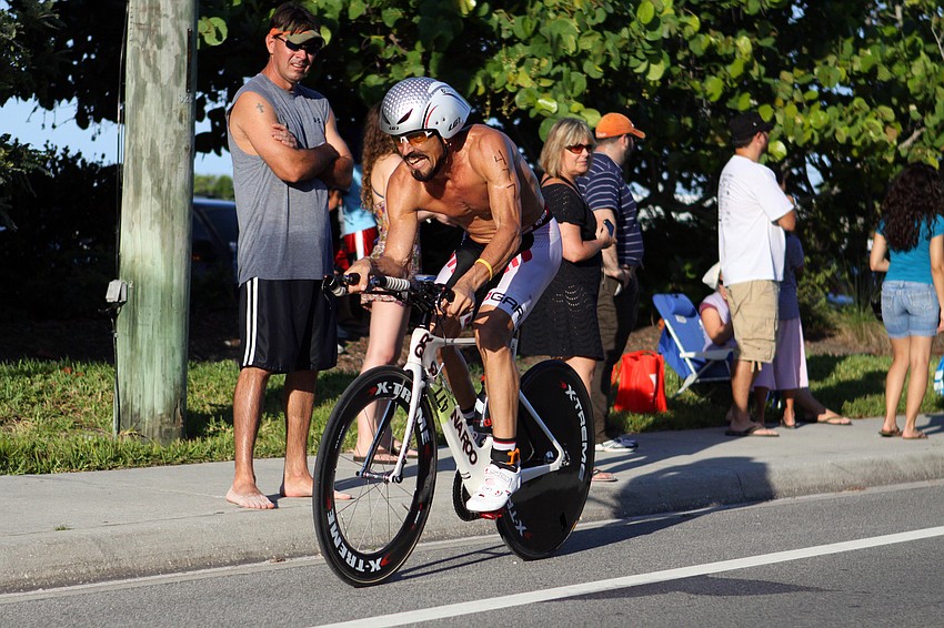 Roger Travis bikes down Beach road as part of his duathlon race. He placed first in his division and 9th overall.