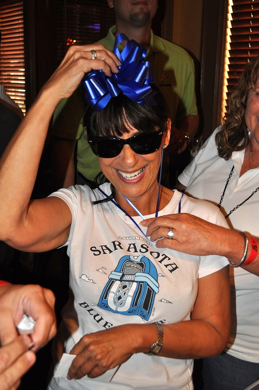 A bow was put on Barbara Strauss' head during the birthday celebration by the pool table Saturday, August 13 during the Kick Off Party at the Gator Club.