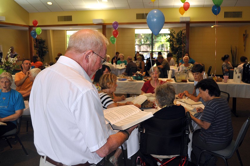 People joined in to sing hymns after finishing their ice cream Sunday, August 14 during the ice cream social in the Parish Hall at St. Boniface.