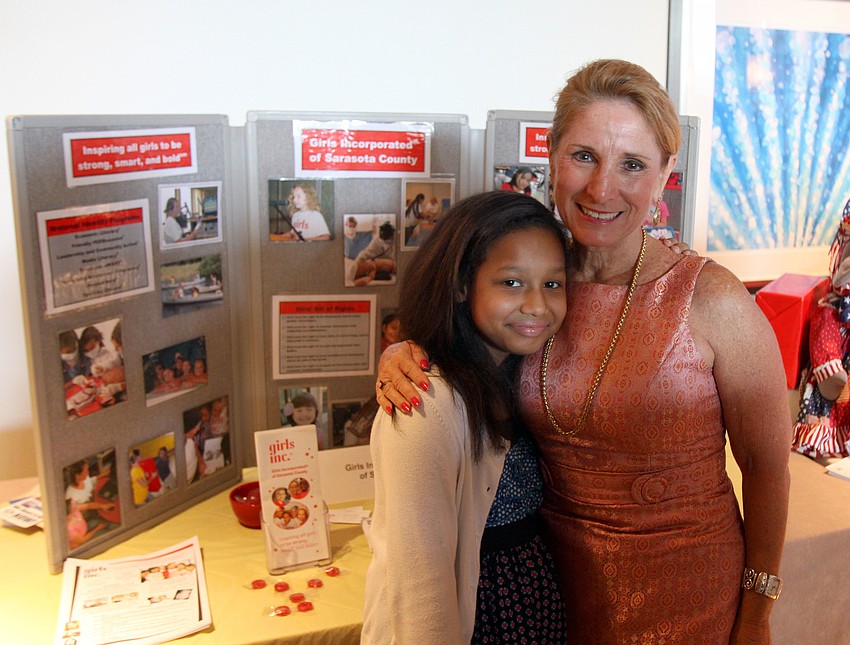 Trinity Villalta, 11, and Stephania Feltz of Girls, Inc. pose together at their display table Saturday, Aug. 20 at the Hyatt Regency Sarasota.