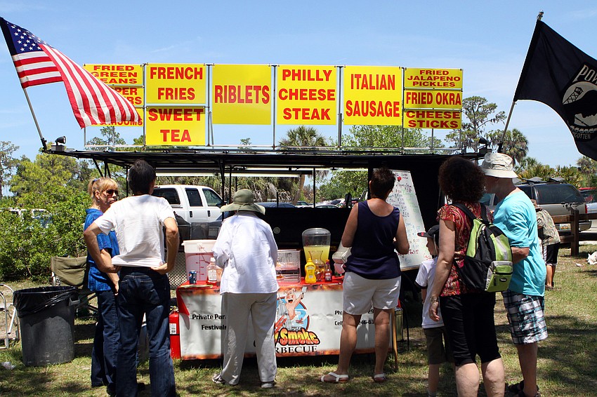 People line up for some food during the Earth Day Celebration on Sunday, April 17 out at Oscar Scherer State Park in Osprey.