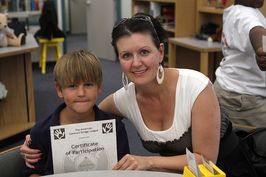 Atilla Szalay and Ildiko Nyeste pose together with Szalay's Certificate of Participation during the Bridge Club's final meeting Monday, May 23 inside Gocico Elementary School's Media Center.