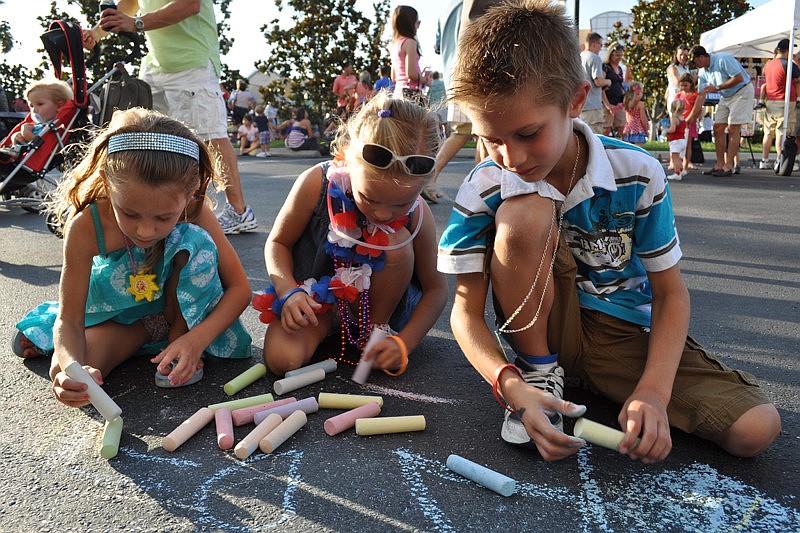 Ava Thompsen, left, with her cousin, Allie, and brother Matthew,  got creative with the sidewalk chalk.