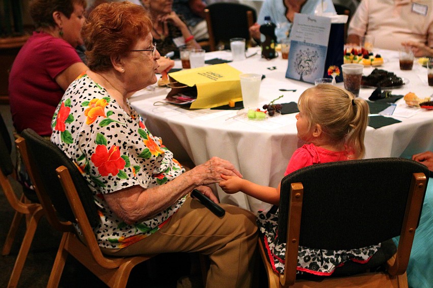 Alice Moubray shakes her great-grand-daughter's, Madison Slydel, 2, hand to the beat of the live jazz music played by the Katt Hefner Trio during the annual National Cancer Survivors Day celebration Sunday, June 5 at Michael's on East.