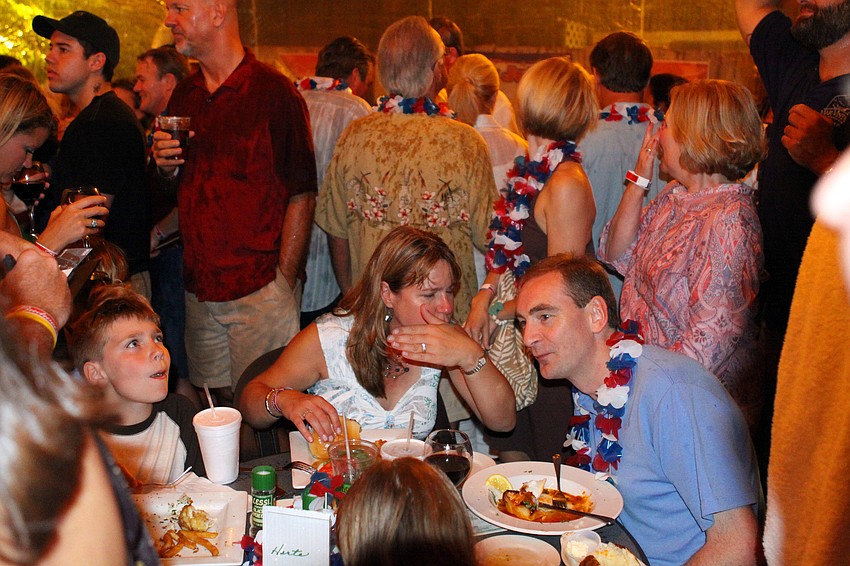 The Harte family from New Jersey attempted to continue eating their meal while tons of people crowded around their table trying to stay dry.