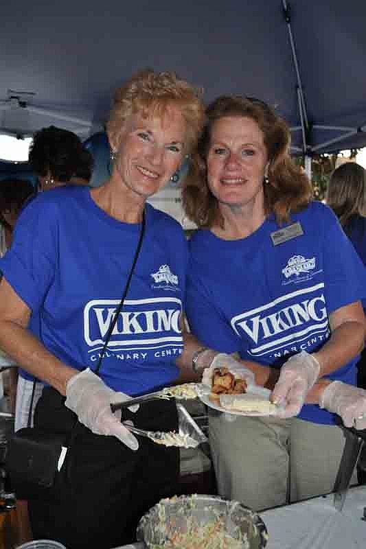 Carol Woods and Laurie Eshleman of Paradise Homes served up barbecue for Viking Cooking School.