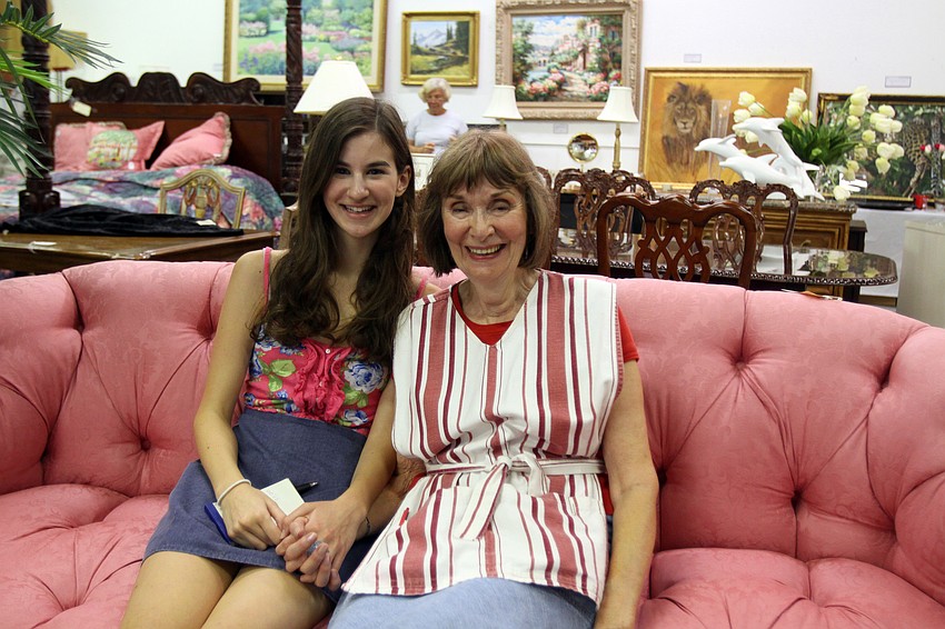 Courtney Hoblock, 15, with her grandmother, Joan Wilson, Friday, July 22 at the estate sale. Hoblock volunteered to help Wilson set up and run the estate sale.