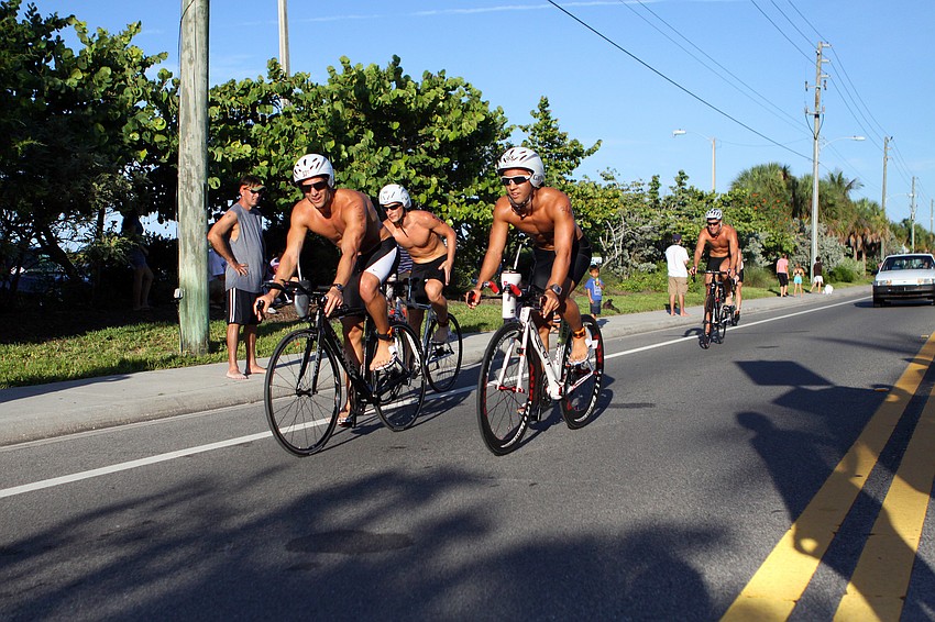 A group of triathletes made their way through the busy roads of Siesta Key Village.