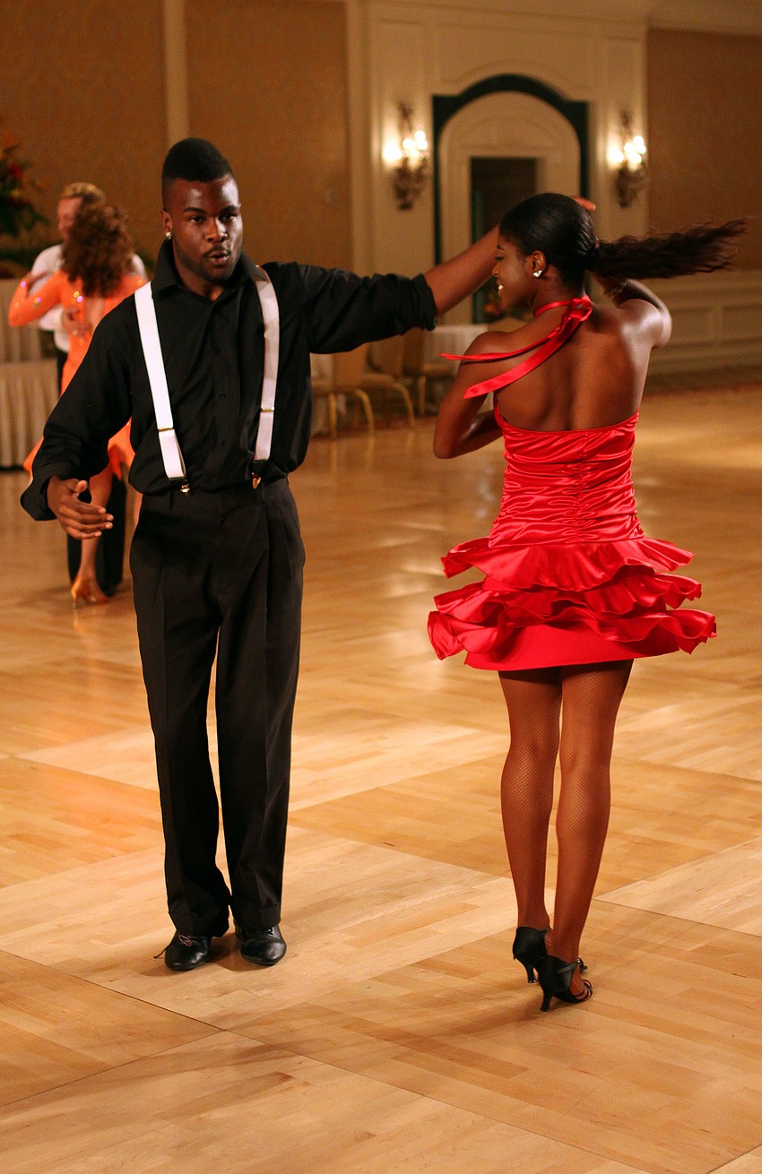 Spats Cats dancers Chad Newell spins his dance partner, Jaayd Mitchell-Vegas, Wednesday, August 3 during the Florida State DanceSport Championships at the Ritz Carlton Sarasota.
