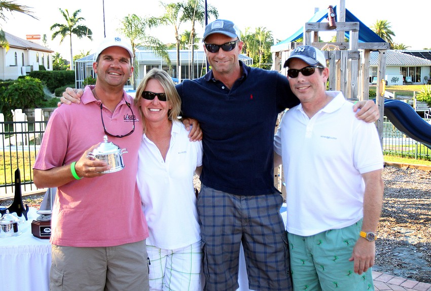 Dave Hillmyer, Donna Steele, Xander Slort and Dave Banyard pose together after winning 1st place in the Windward Leg with their boat 