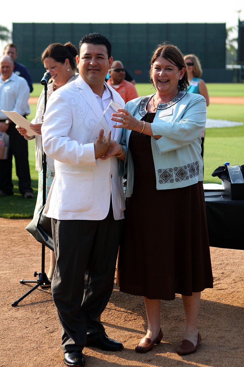 Cesar Ruiz of Ritz Carlton-Sarasota accepts the award for Guest Service Excellence - Back of House - Lodging at the 2011 National Tourism Week Awards ceremony Thursday, May 12, at Ed Smith Stadium.
