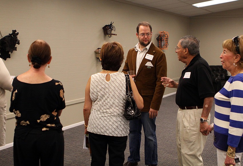 Nathan Skiles talks to some of the people attending the opening of the RCAD Creatives Exhibition Thursday, May 19 at Longboat Key Center for the Arts.