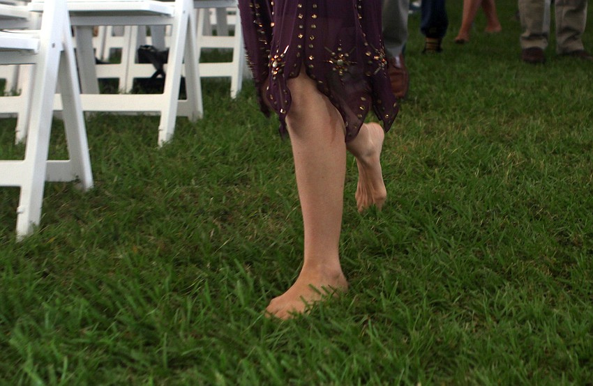 Breyten Vanderberg, 4, enjoys his macaroni and cheese while sitting with Bernard Vroom and Nicole Vanderberg, a staff member at New College, during New College's 2011 Commencement ceremony Friday, May 20 at College Hall Bay Front.