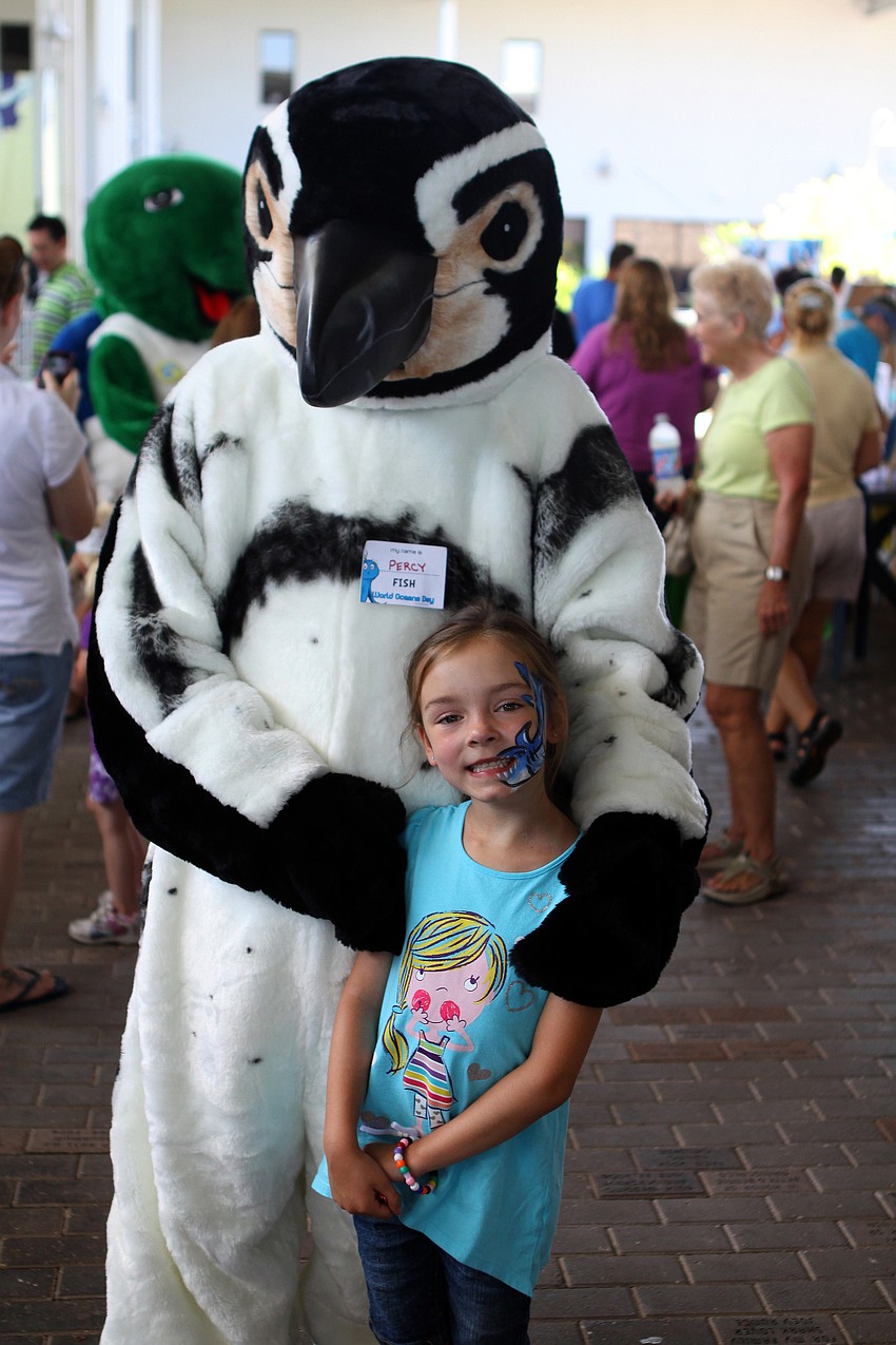 Ava Henegar poses with Percy at World Ocean Day Family Festival Sunday, June 5 at Mote Aquarium.