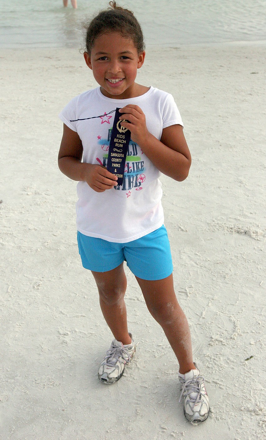 Dakota Salem, 8, was the first girl to cross the finish line in the 1-mile fun run Tuesday, June 14 on Siesta Key Beach.