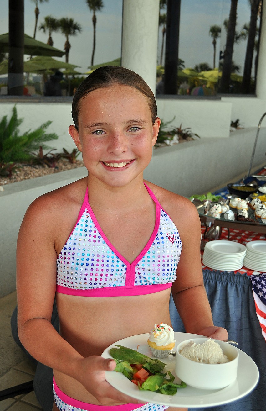 Lily Rutledge gets some dessert and a little bit of salad Sunday, July 3 at the Lobster BBQ by the pool at Longboat Key Club Resort.