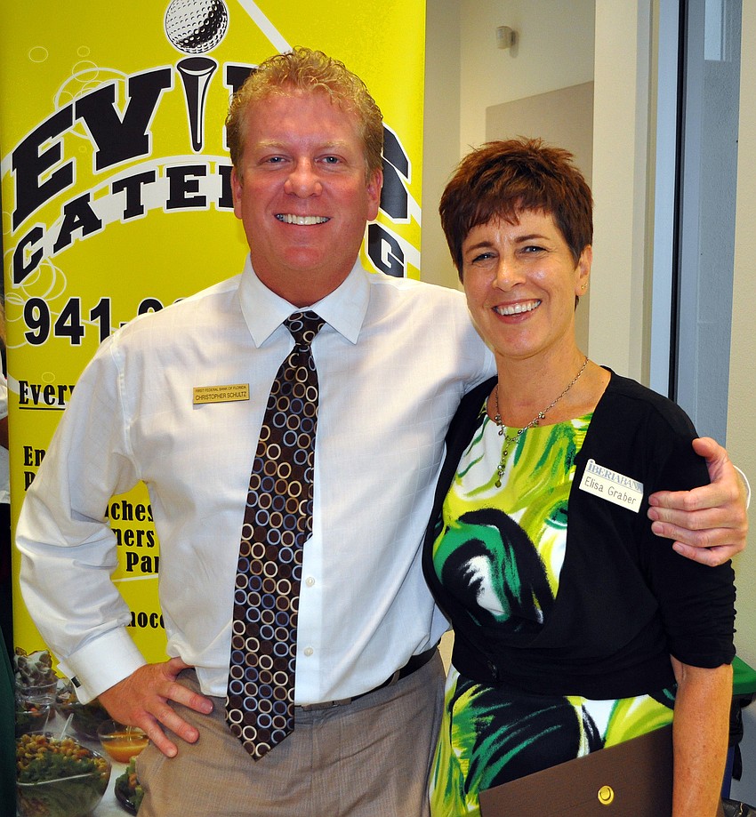 Christopher Schultz, of First Federal Bank of Florida, and Elisa Graber, of Iberia Bank, pose together Wednesday, July 13 at Sarasota Prime Time.