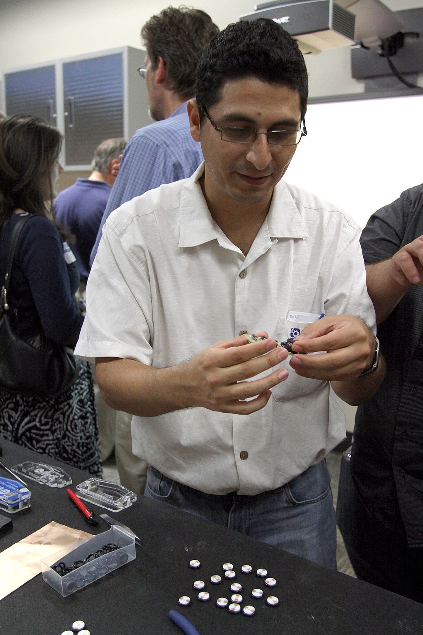 Roberto Guerra puts together an electronic ruler at the opening of the G. WIZ Faulhaber Fab Lab Thursday, May 5 at G. WIZ.