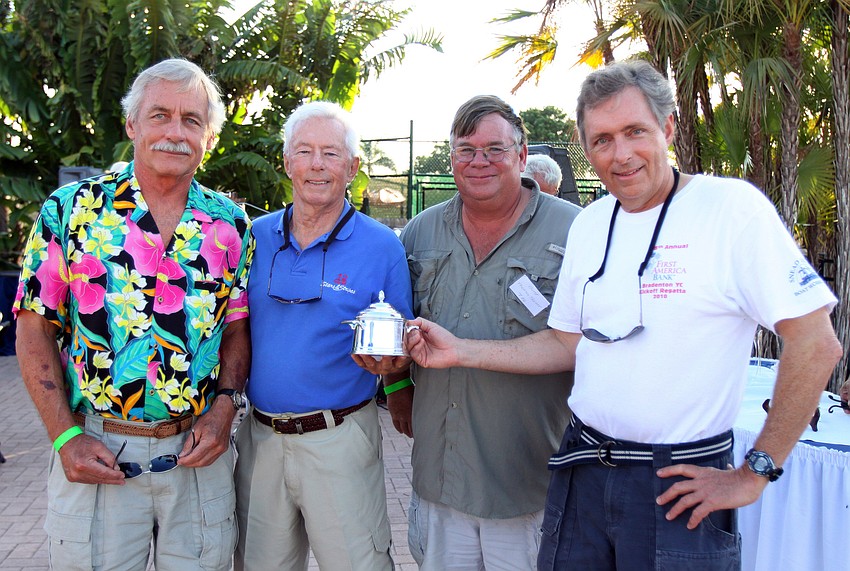 Roger Koehn, Thomas Fugina, Thomas Turner and Doug Derden pose for a photo after winning first place in the Random Leg with their boat 