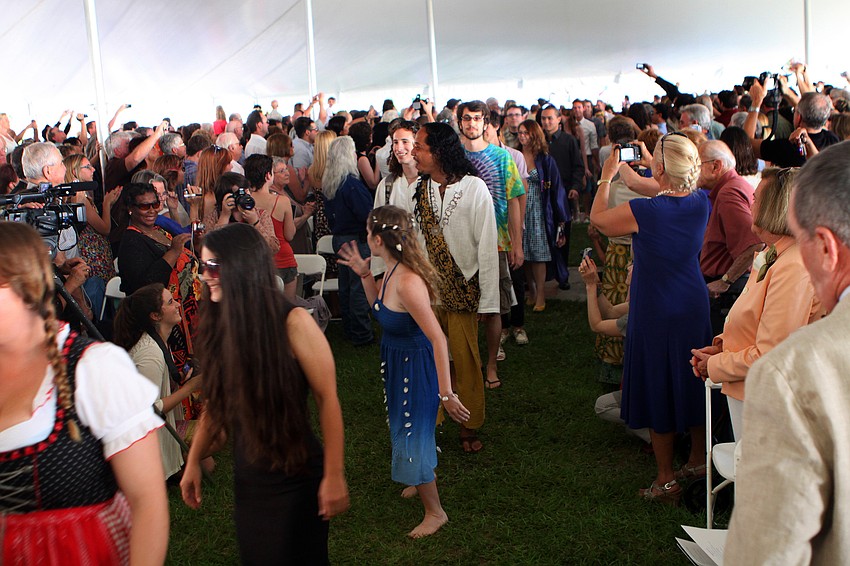 Friends and family clap, cheer and take photos as the class of 2011 makes their way to their seats for New College's 2011 Commencement ceremony Friday, May 20 at College Hall Bay Front.