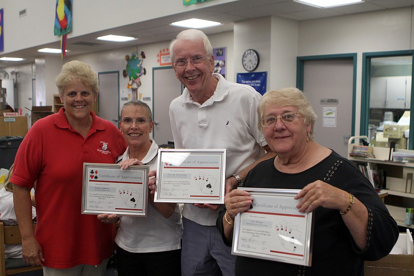 Debra Voege, Psychological Coordinator for the Go-Getters 21st Century Community Learning Center, handed out framed awards to the bridge coaches Kathy Lammert, George Kenworthy and Iris Wilson who all helped with Gocio's after school bridge program.